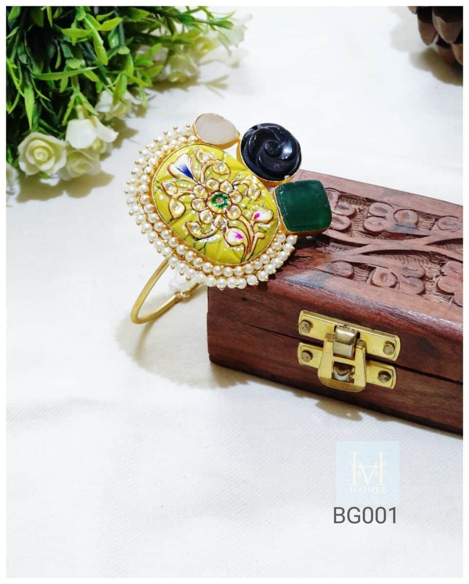 Adjustable gold plated cuff with hand painted Tanjore art & imitation pearls. Unique Indian cultural jewelry. Shop this statement bracelet now!