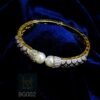 Gold Plated honeycomb cuff bangle with seed pearl and Zirconia embellishments. Glamorous Indian party wear. Shop this unique bracelet now!