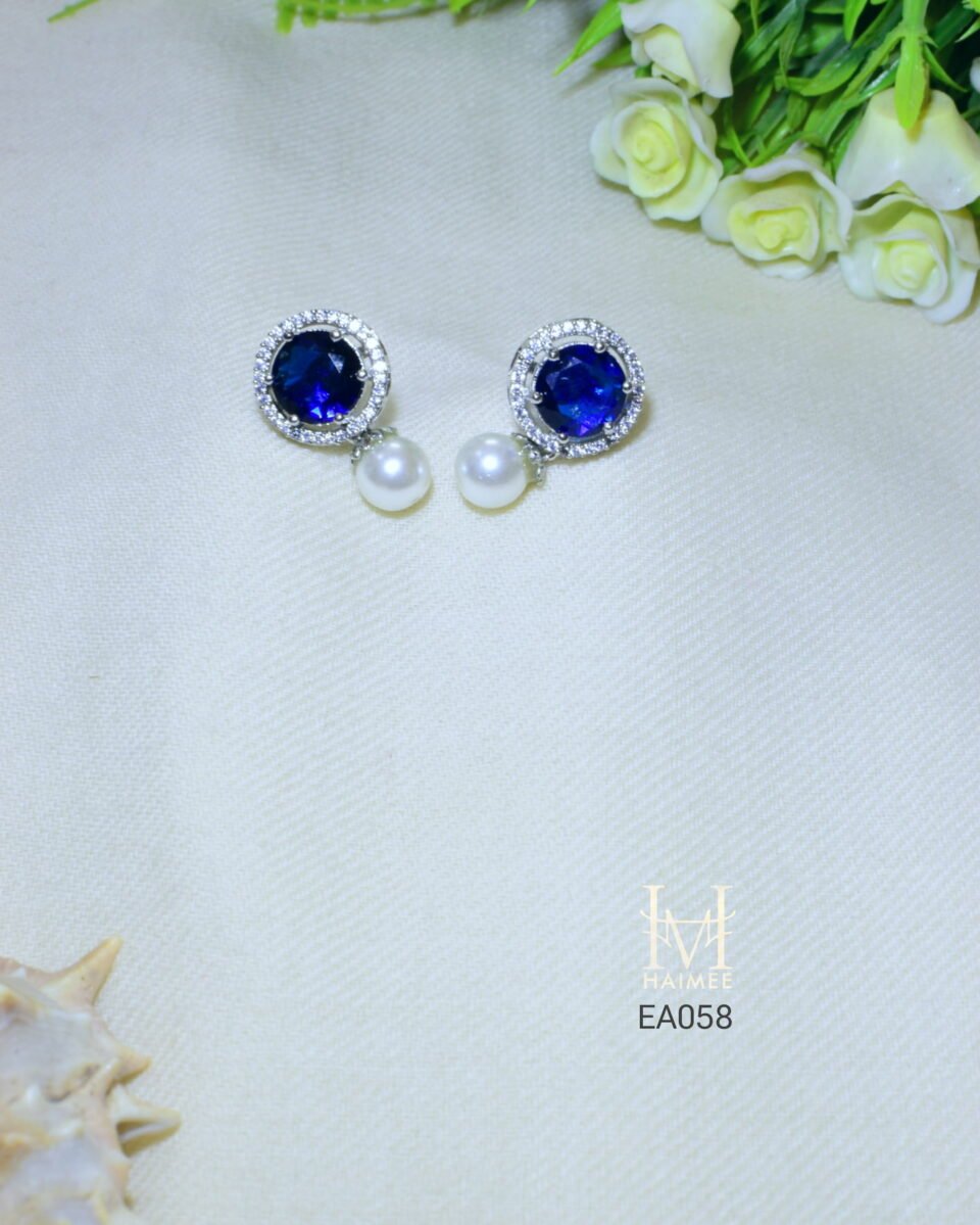 Elegant cultured pearl drop earrings featuring sparkling emerald cut CZ stones in art silver setting. Ideal for adding a touch of sophistication.