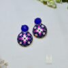 Floral Meenakari earrings featuring a vibrant blue pattern and a dark stone stud. Gold plated, hand painted by local artisans. Discover them today! Jaipur Jewellery