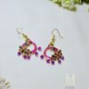 Indian peacock earrings with pink Meenakari and imitation pearl embellishments. Gold- plated, perfect for everyday wear. Discover these unique earrings today!