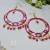 Hand painted pink Meenakari hoop earrings chaand baali with floral designs and seed pearl drops. Perfect for festive occasions. Designed for women aged 25-40. Shop now