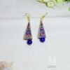Geometric drop earrings with vibrant Meenakari designs and a smooth blue ceramic bead. Gold plated, hand painted by Indian artisans. Discover them today!