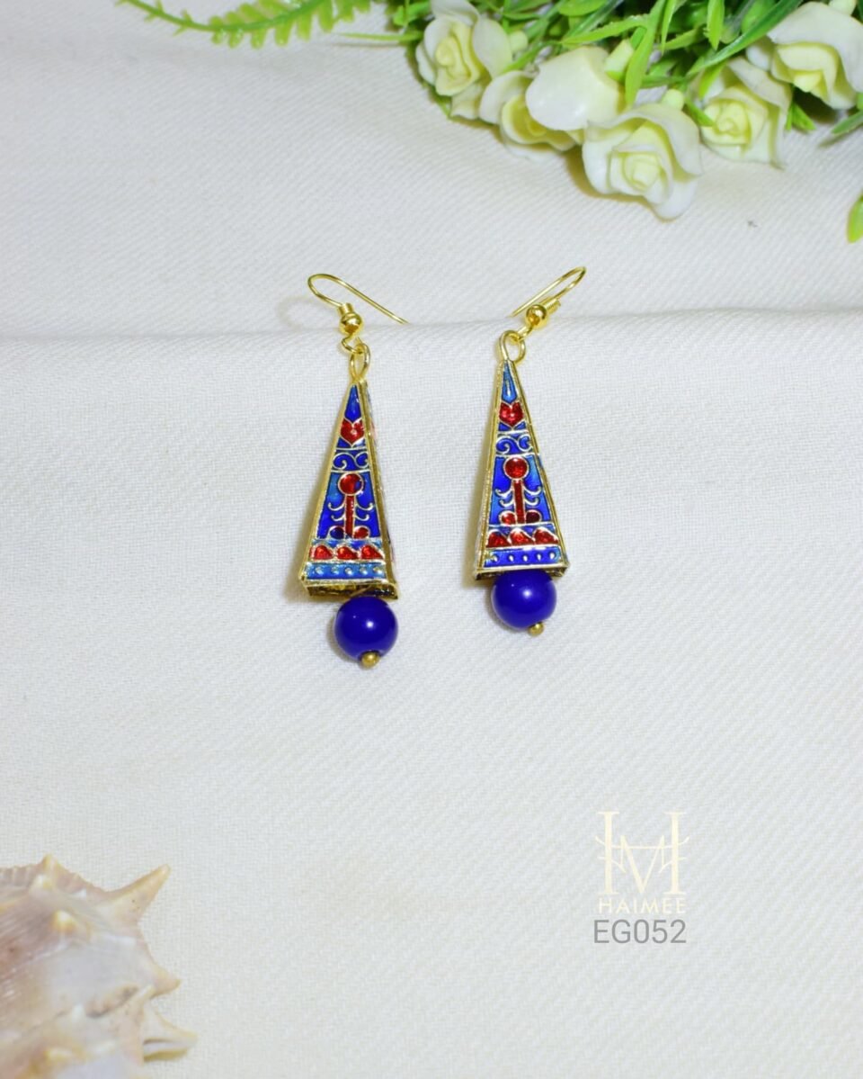 Geometric drop earrings with vibrant Meenakari designs and a smooth blue ceramic bead. Gold plated, hand painted by Indian artisans. Discover them today!