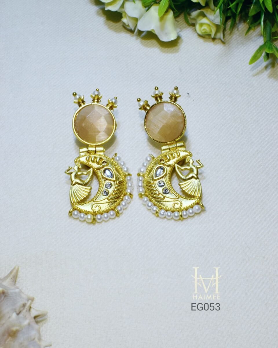 Gold plated dancing lady drop earrings with a unique stone setting and delicate seed pearl trim. Perfect for festive wear. Shop these Indian-inspired earrings now!