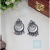 Silver crescent moon-shaped tribal earrings with intricate detailing, presented on a product page for tribal jewellery online India.