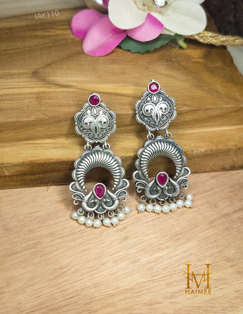 Indian Traditional Design Silver Oxydized Earrings with stone placed on wooden surface