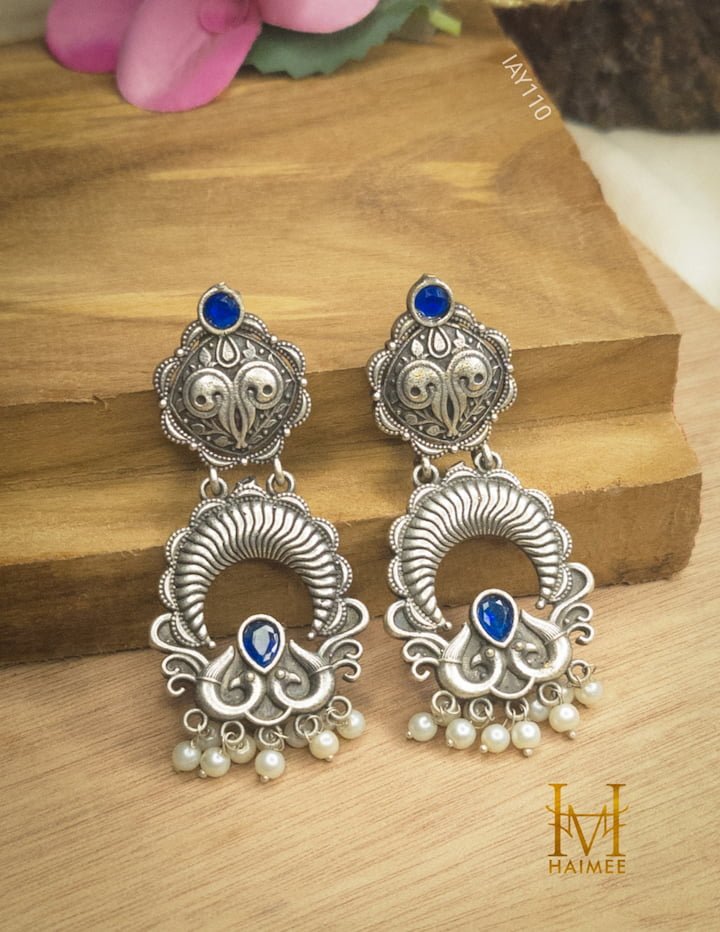 Blue stone Indian Traditional Design Silver Oxydized Earrings placed on wooden surface