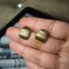 premium gold plated anti tarnish stud earrings in hand for size reference