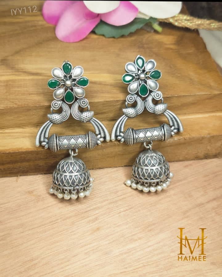silver oxydized jhumka of brass with pearl motifs and green stones