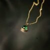 Elevate your everyday look with this polished anti tarnish, gold plated bezel green crystal triangle pendant necklace. The hypoallergenic, water resistant properties ensure both style and comfort. Shop now at Haimee.