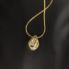 Elevate your elegant look with this polished gold plated anti tarnish fluid shape pendant necklace. The single CZ stone, snake chain, and hypoallergenic, water resistant properties ensure both style and comfort.
