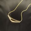 Shop curved tube chokers from Haimee. Made from gold plated, anti tarnish, hypoallergenic stainless steel, these minimalist chokers offer modern elegance and durability.