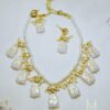 Trapezoid white stone necklace featuring gold Meenakari designs and pearl beads. Gold plated setting. Ideal for adding a touch of elegance to your party look.