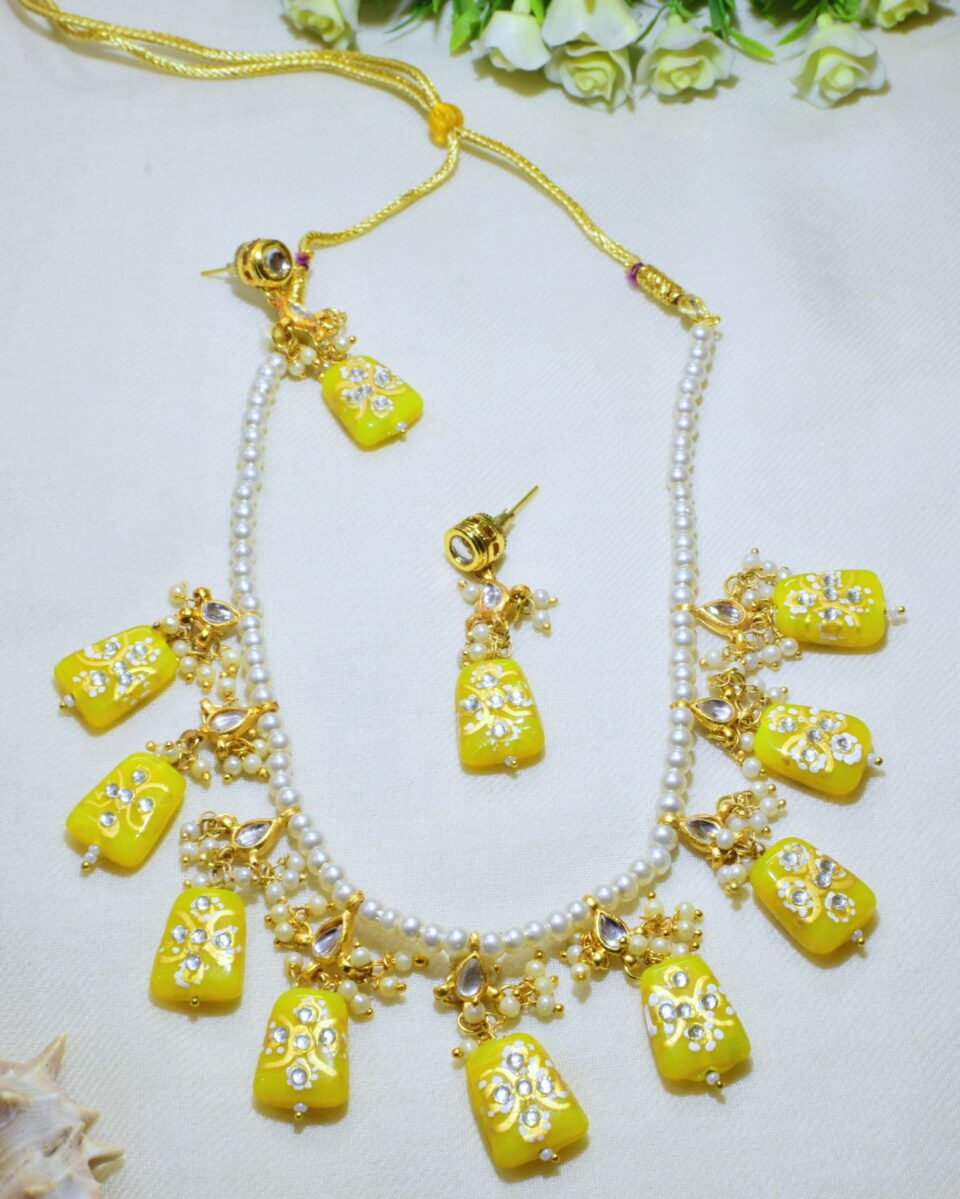Handmade yellow Monalisa necklace with trapezoid stones and gold Meenakari work. Perfect for parties. Pearl bead base. Shop this unique set for women