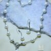 Cultured freshwater black pearl necklace set with earrings, featuring elegant silver accents and a timeless design.