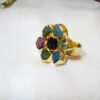 Raw cut gemstone ring featuring vibrant mixed colors in a smooth gold-plated setting. A statement piece for party wear. Discover this artisan ring for gemstone lovers