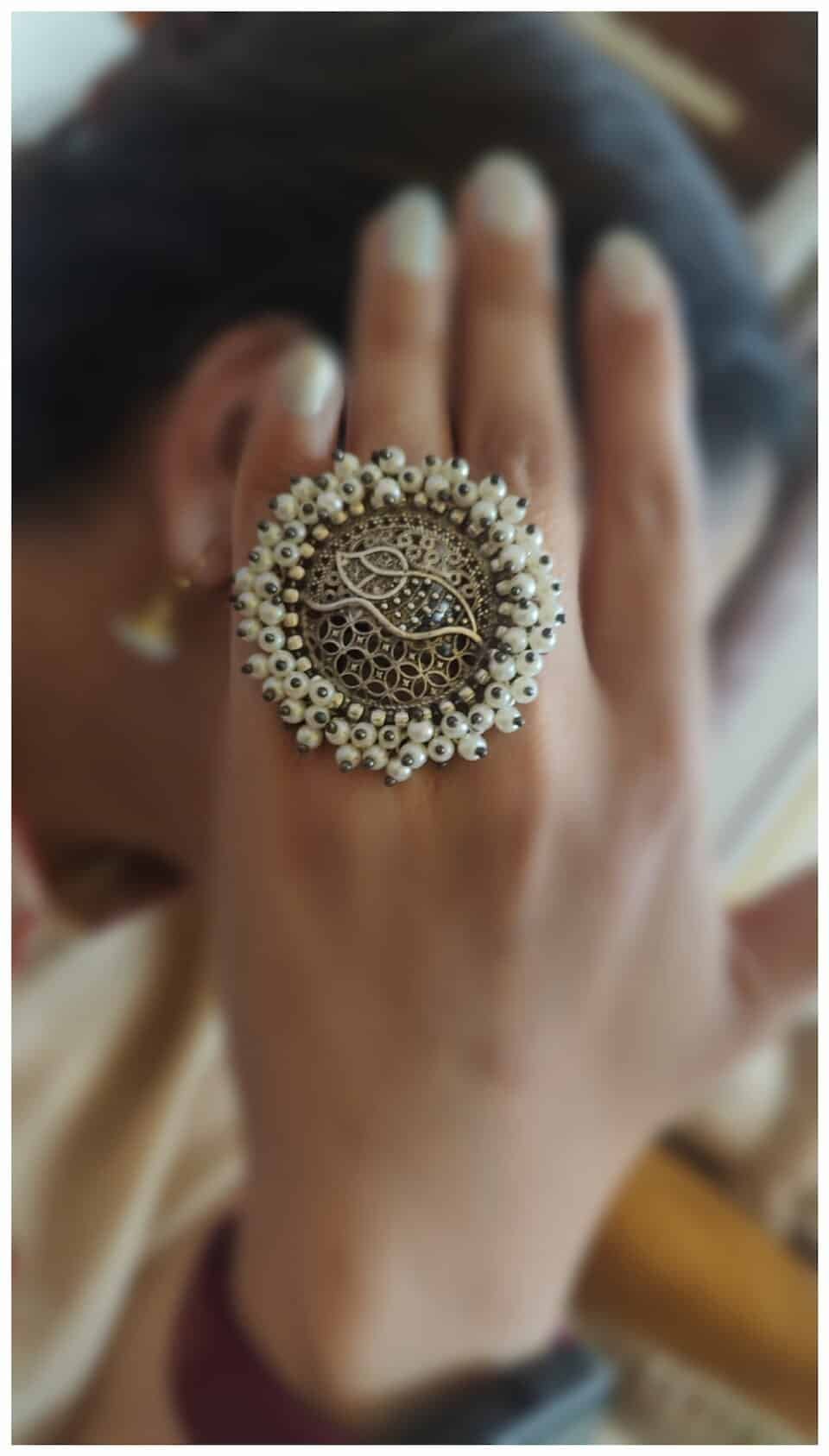 Silver Oxydised adjustable ring with Garjra moti work on a hand