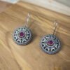 Brass Jewellery, Silver Oxidized earrings with stone placed on wooden surface