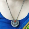 Ethnic temple jewelry style necklace featuring orange lab stone and oxidised finish