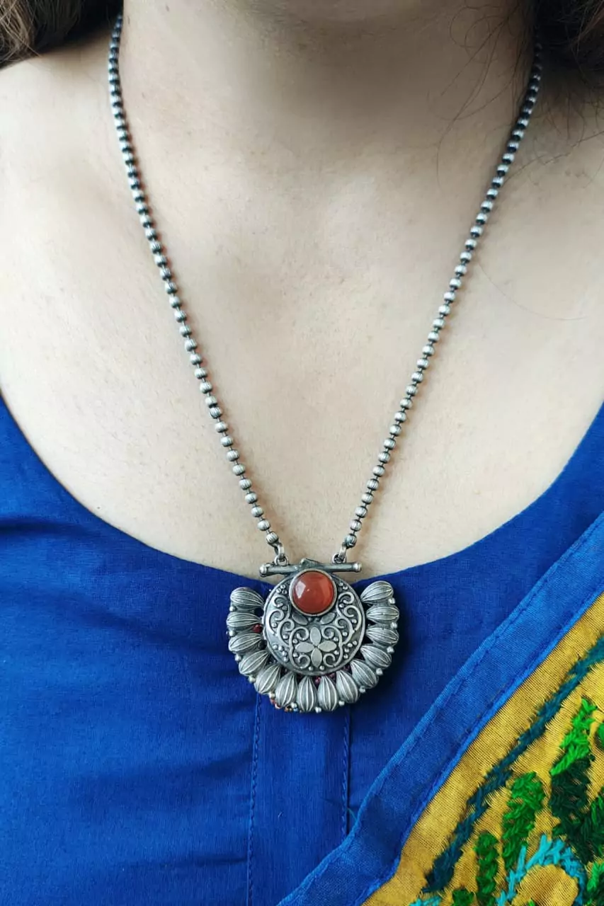 Ethnic temple jewelry style necklace featuring orange lab stone and oxidised finish