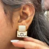 HAND PAINTED EARRING IN EAR