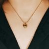 GIRL WEARING A HEART SHAPE ANTI TARNISH NECKLACE